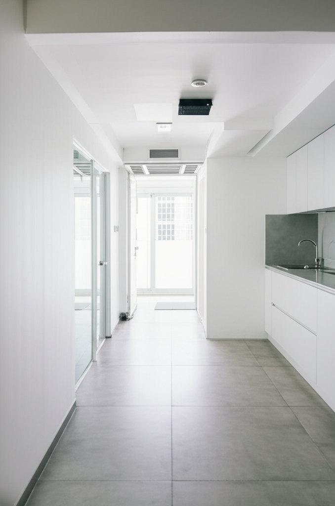Professional photograph of a minimalist condo interior in Singapore. Soft lighting. Symmetrical composition. Peaceful atmosphere. No text or logos.